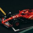 Dynamic shot of a red Formula One car racing on a track, showcasing speed and precision.