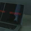 Close-up of a laptop displaying cybersecurity text, emphasizing digital security themes.