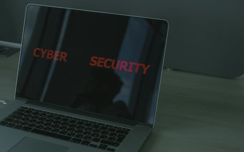 Close-up of a laptop displaying cybersecurity text, emphasizing digital security themes.