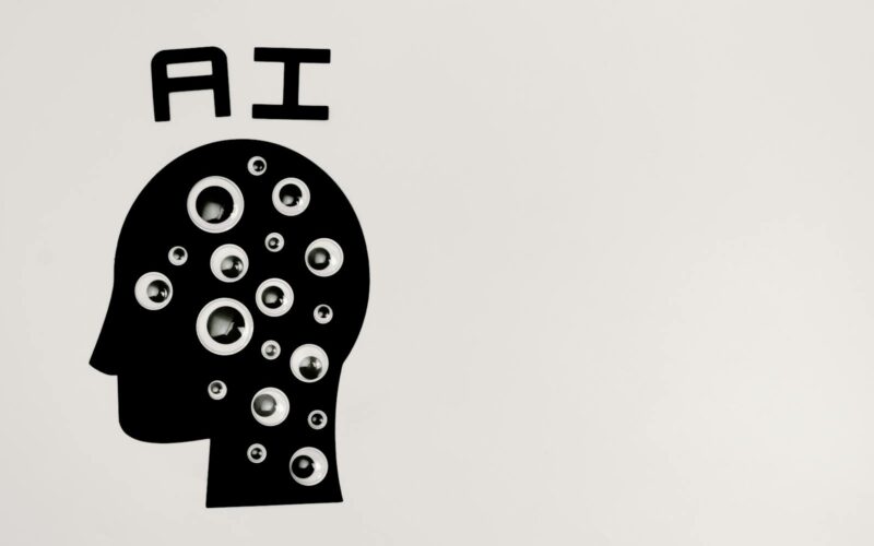 Abstract illustration of AI with silhouette head full of eyes, symbolizing observation and technology.