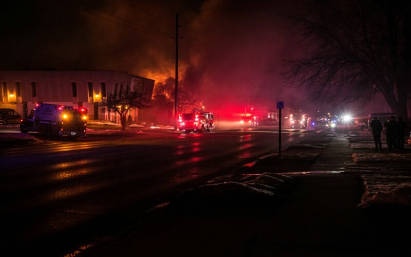 fire truck beside burning house during nighttime