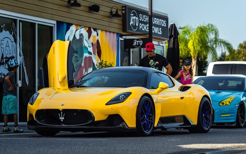 A yellow sports car parked in front of a store