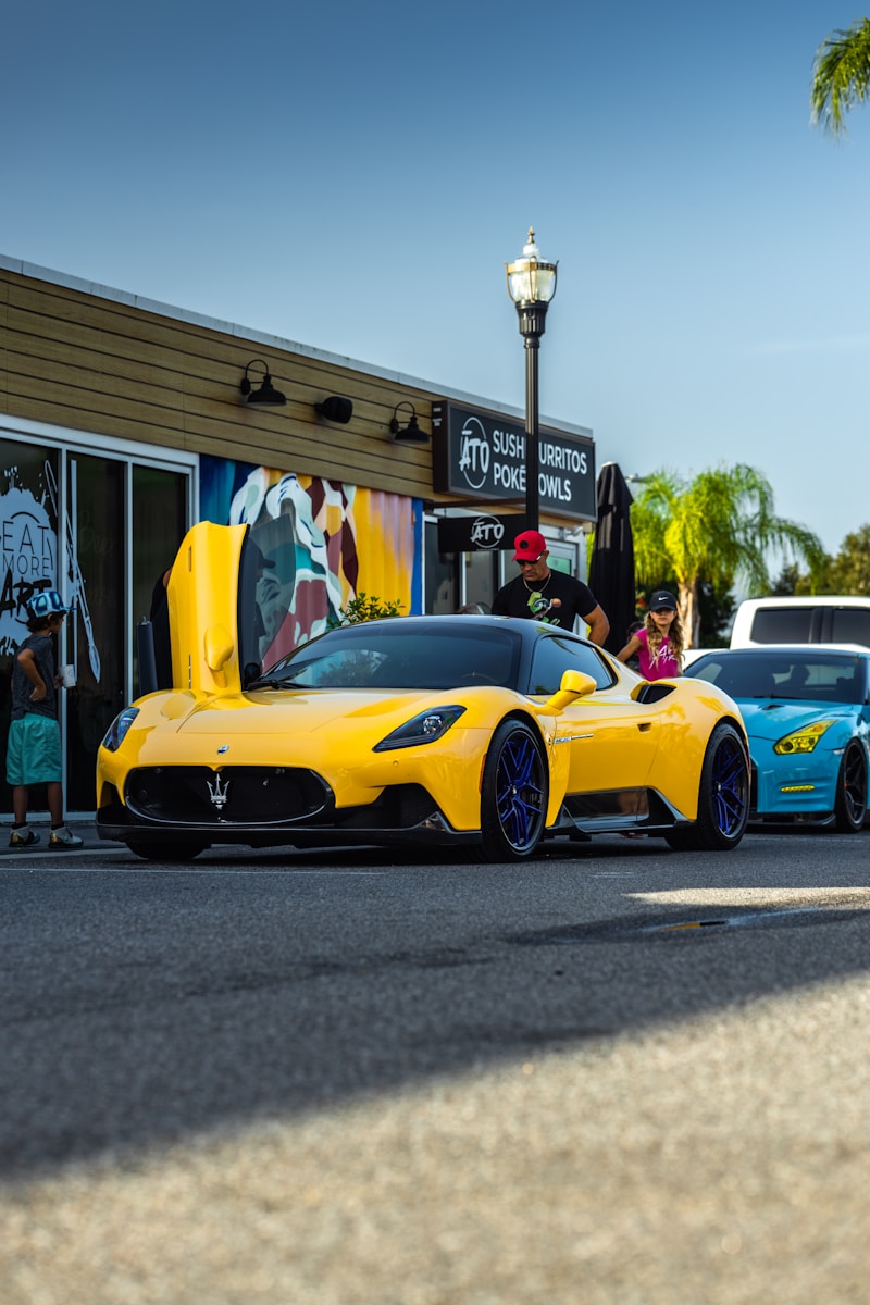 A yellow sports car parked in front of a store