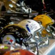 a row of football helmets sitting on top of a table