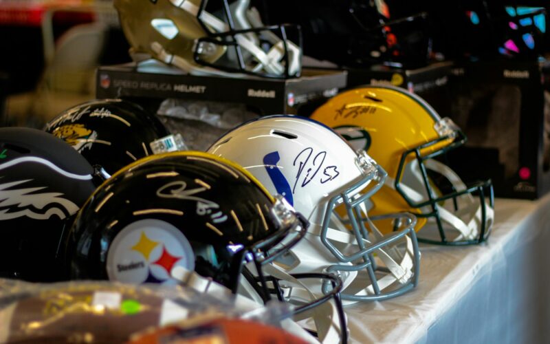 a row of football helmets sitting on top of a table