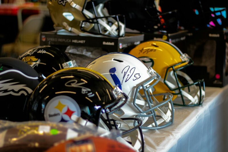 a row of football helmets sitting on top of a table