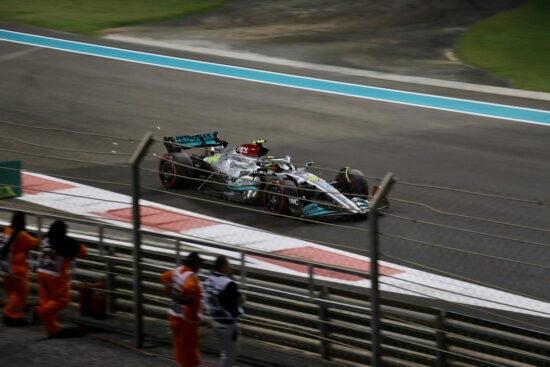 Mercedes Formula 1 car races at Abu Dhabi's Yas Marina Circuit, showcasing speed and precision.