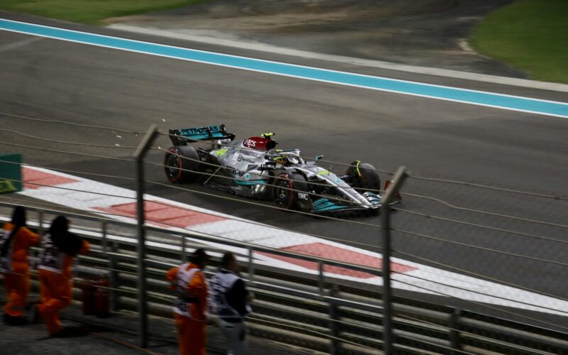 Mercedes Formula 1 car races at Abu Dhabi's Yas Marina Circuit, showcasing speed and precision.
