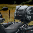 motocicleta offroad cu bagaje aditionale fotografiata pe un drum de tara