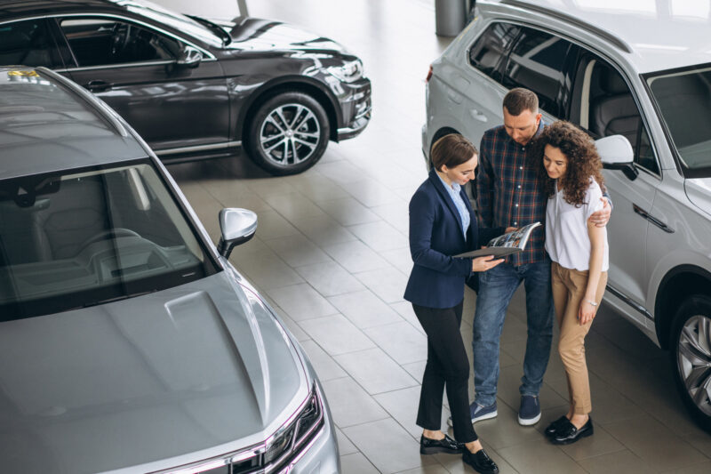 doi clienti discuta cu un dealer auto