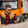 un sofer de camion isi verifica telefonul