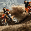 doua motociclete off road portocalii cu un munte in fundal