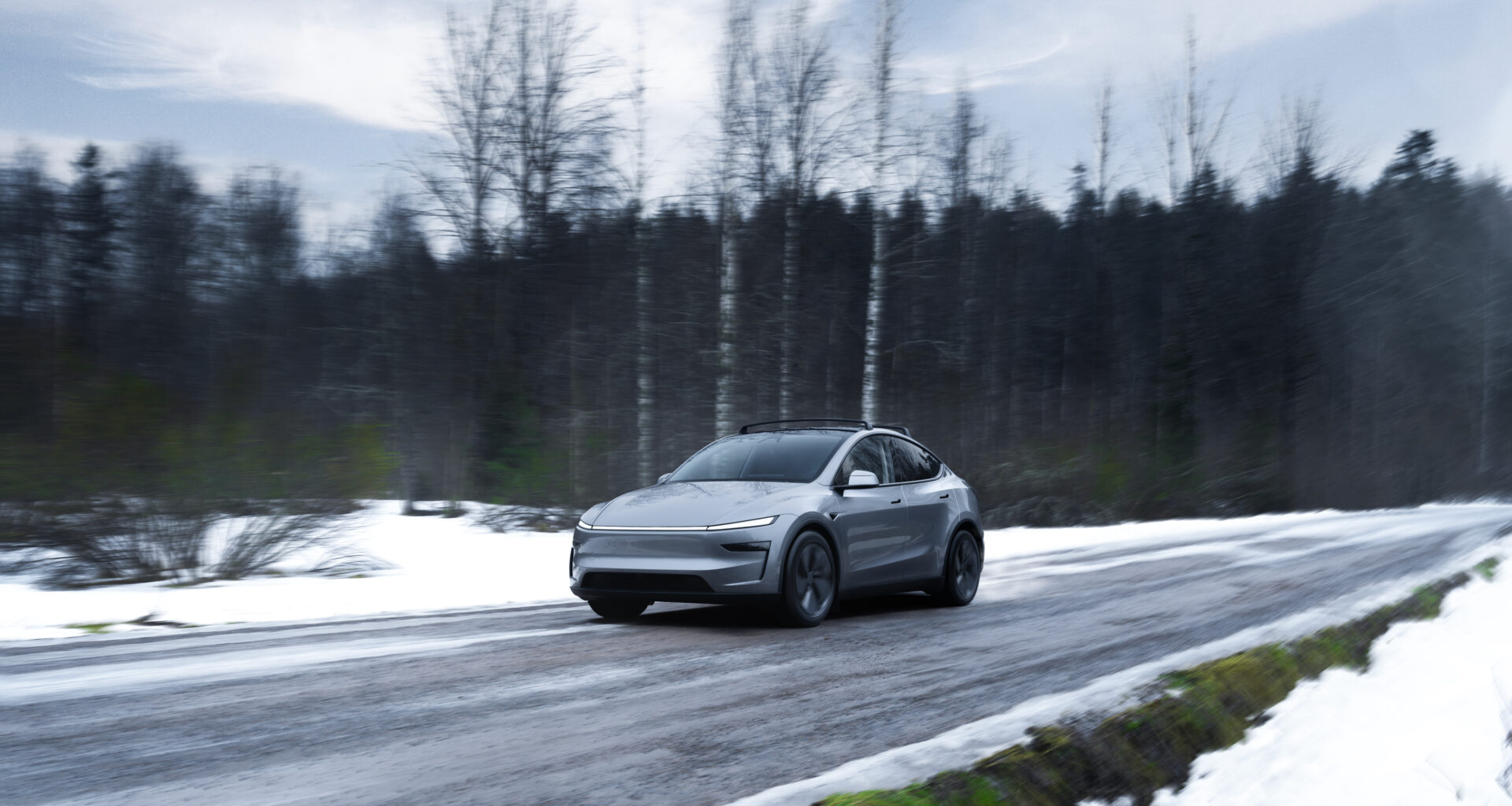 Tesla Model Y conducând pe un drum acoperit de zapada