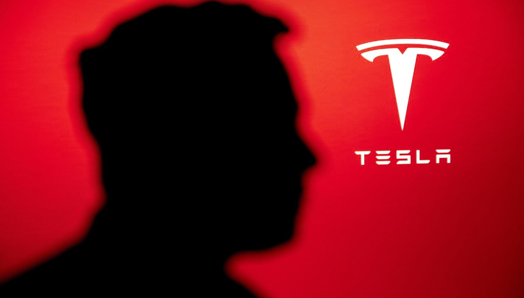 Logo-ul Tesla alături de silueta miliardarului american Elon Musk