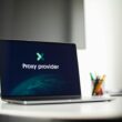 Laptop screen showing 'Proxy provider' in a tech office setting, focus on cybersecurity.