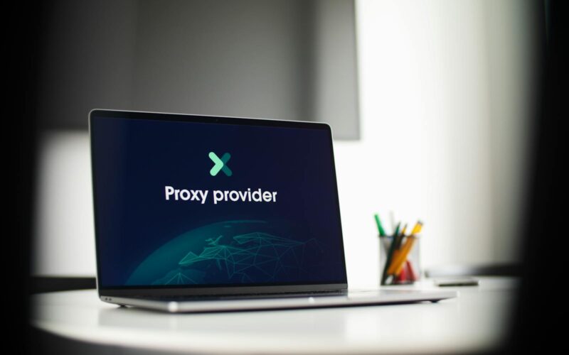 Laptop screen showing 'Proxy provider' in a tech office setting, focus on cybersecurity.