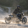 motocicleta clasica neagra pe teren accidentat