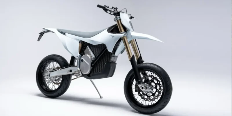 motocicleta electrica de culoare alba si tip super moto pe fundal gri