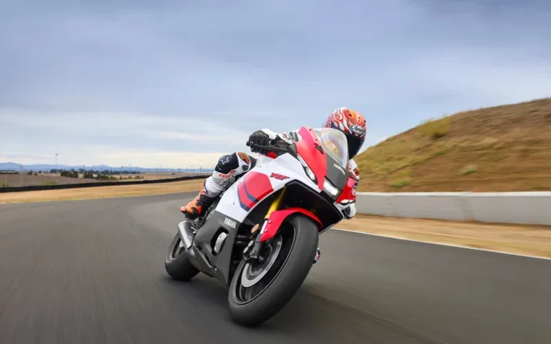 motocicleta super sport de culoare rosie inclinata pe partea dreapta pe circuit